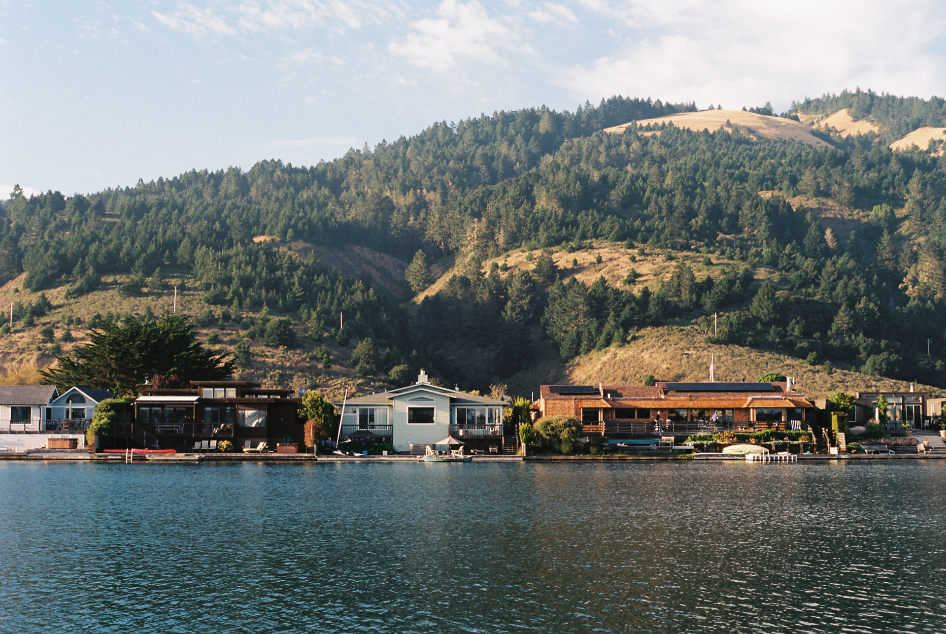 Color photo of a houses on a bay in daylight.
